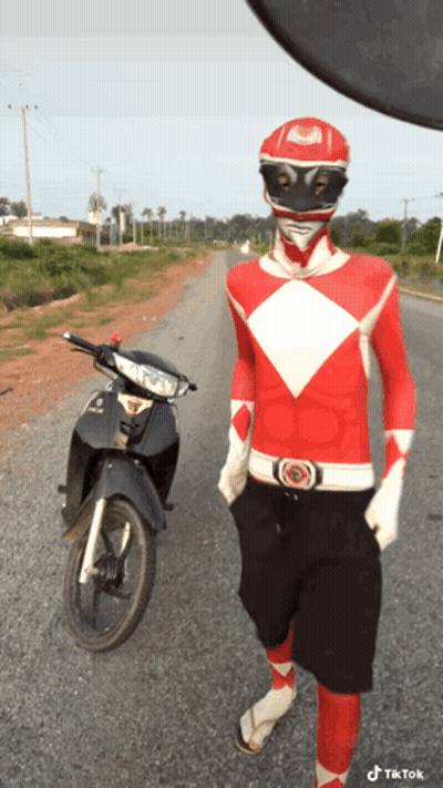 Man In Red Power Ranger Costume Next To Motorcycle GIF