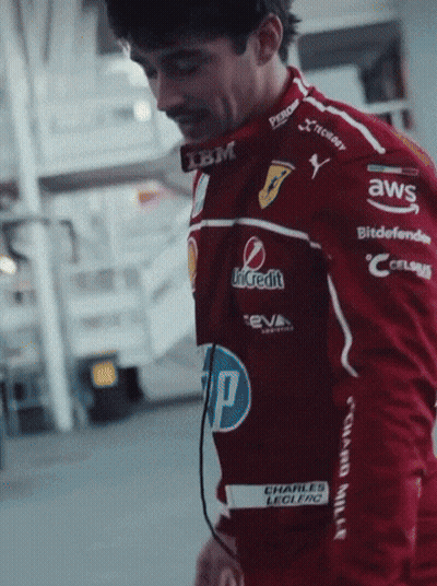 Man In Red Racing Jacket With Sponsors GIF