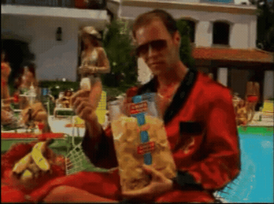 Man In Red Robe Holding Bag Of Doritos Chips GIF