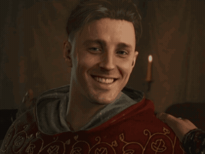 Man In Red Robe Smiling At Camera GIF
