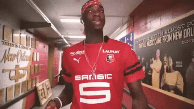 Man In Red Sansic Shirt Standing In Hallway GIF