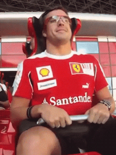 Man In Red Santander Shirt Sitting GIF