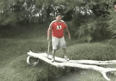 Man In Red Shirt 83 Standing On Log GIF