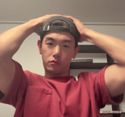 Man In Red Shirt Adjusting Black Hat GIF
