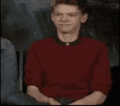 Man In Red Shirt And Black Collar Close Up GIF