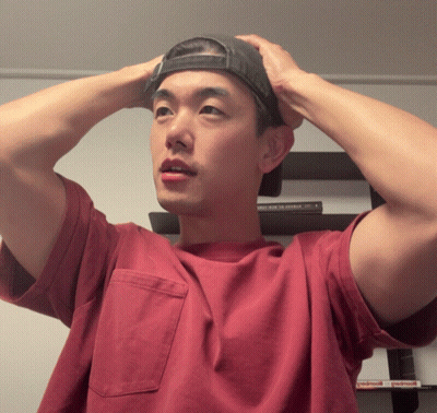 Man In Red Shirt And Black Hat Adjusting Hat GIF