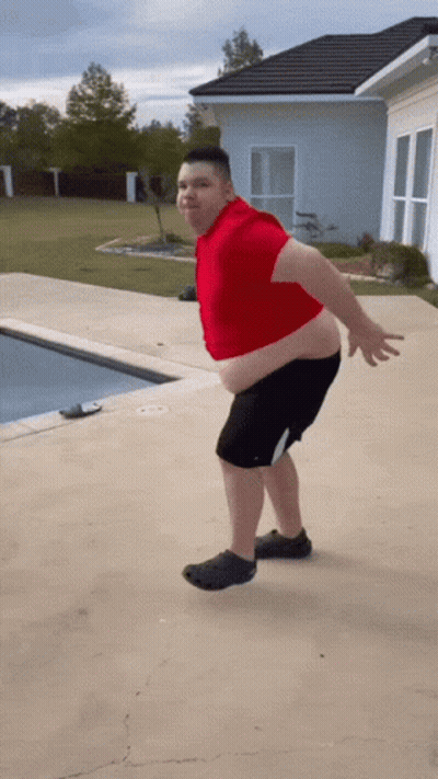 Man In Red Shirt And Black Shorts At Swimming Pool GIF