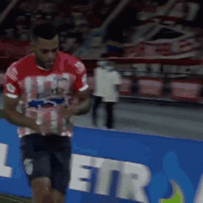 Man In Red Shirt And Black Shorts On Soccer Field GIF