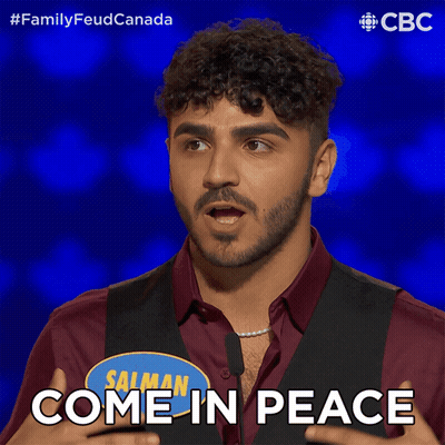 Man In Red Shirt And Black Vest Says Come In Peace GIF