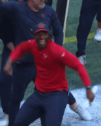 Man In Red Shirt And Blue Hat Next To Another Man GIF