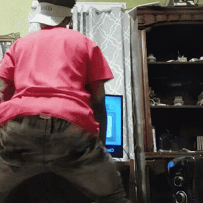 Man In Red Shirt And Hat At Computer GIF