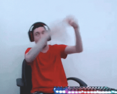 Man In Red Shirt And Headphones At Desk With Keyboard GIF
