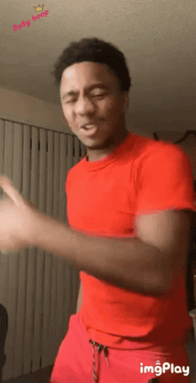 Man In Red Shirt And Red Shorts Dancing In Living Room GIF