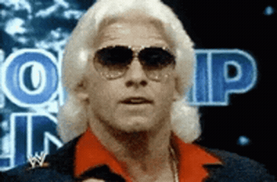 Man In Red Shirt And Sunglasses In Front Of WP Sign GIF