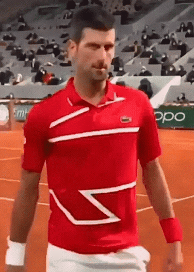 Man In Red Shirt And White Shorts Walking On Tennis Court GIF