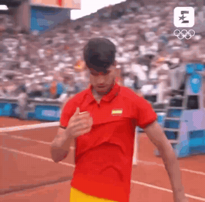 Man In Red Shirt And Yellow Shorts Running On Track GIF