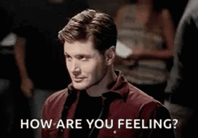 Man In Red Shirt Asking How Are You Feeling In Crowd GIF