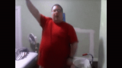Man In Red Shirt At Bathroom Sink GIF