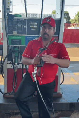 Man In Red Shirt At Gas Pump GIF