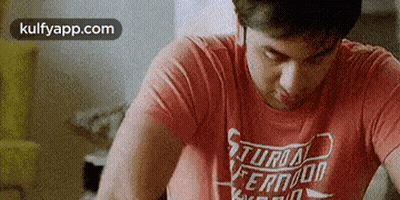 Man In Red Shirt At Table Eyes Closed GIF