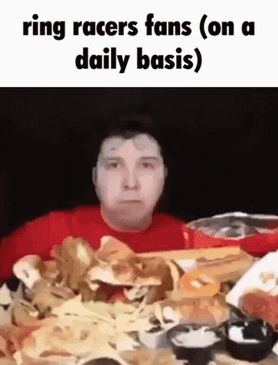Man In Red Shirt At Table With Pile Of Food GIF