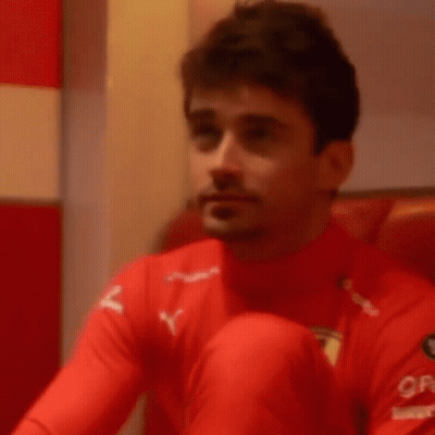 Man In Red Shirt Covering Mouth GIF