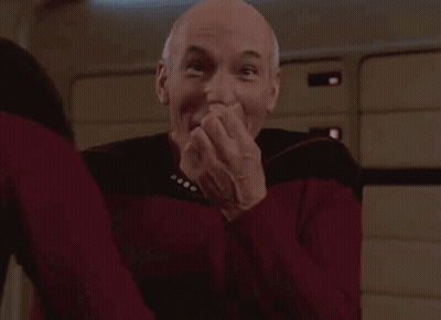 Man In Red Shirt Covering Mouth Laughing GIF