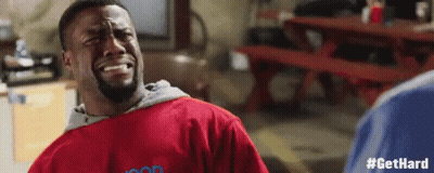 Man In Red Shirt Crying At Picnic Table In Garage GIF