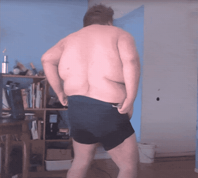 Man In Red Shirt Dancing In Front Of Castro Chair GIF