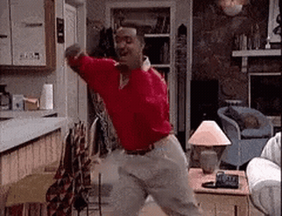 Man in Red Shirt Dancing in Living Room
