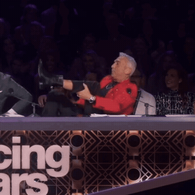 Man In Red Shirt Doing Split In Front Of Dancing With The Stars Sign GIF
