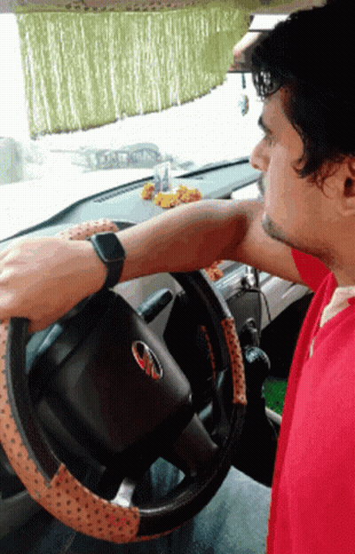 Man In Red Shirt Driving Car With Mahindra Logo GIF