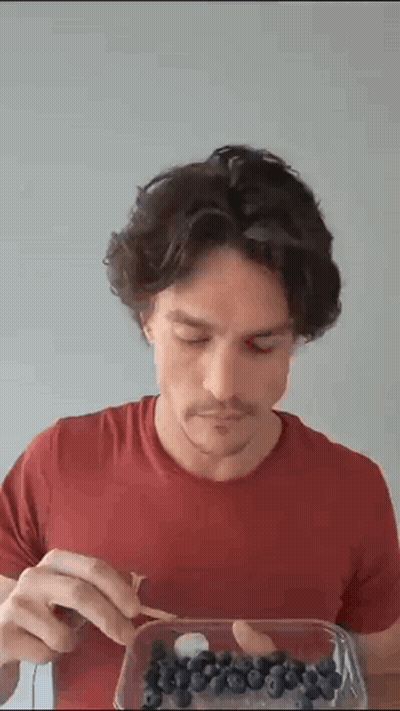 Man In Red Shirt Eating Blueberries GIF