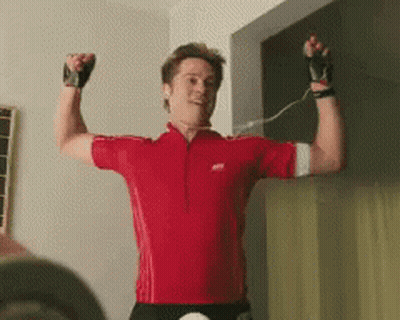 Man In Red Shirt Flexing GIF