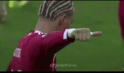 Man In Red Shirt Giving Thumbs Up On Soccer Field GIF