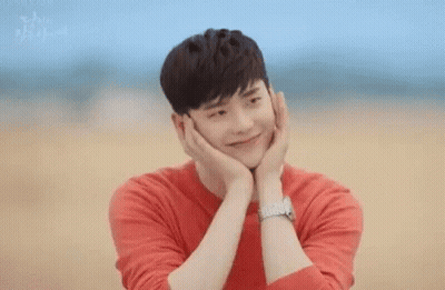 Man In Red Shirt Holding Face Smiling GIF