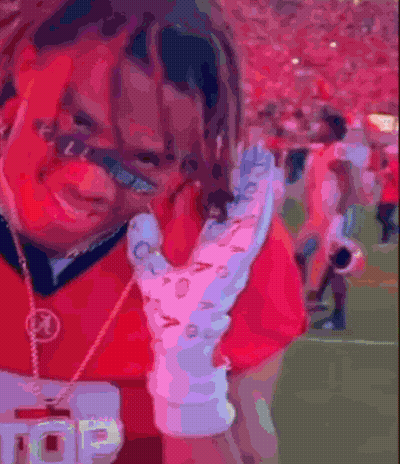 Man In Red Shirt Holding Glove And Badge GIF