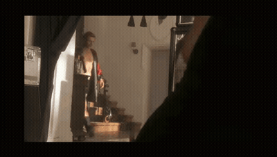 Man In Red Shirt Holding Gun GIF