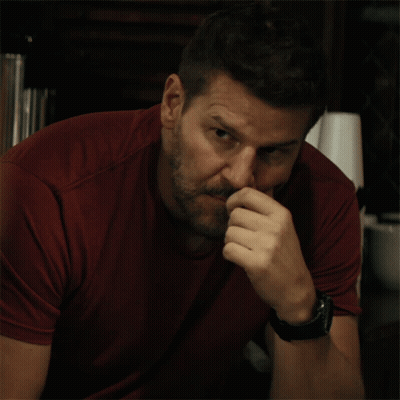 Man In Red Shirt Holding Hand To Nose GIF