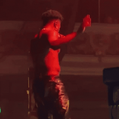Man In Red Shirt Holding Microphone On Stage GIF