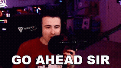 Man In Red Shirt Holding Microphone Says Go Ahead Sir GIF