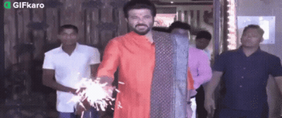 Man In Red Shirt Holding Sparkler GIF