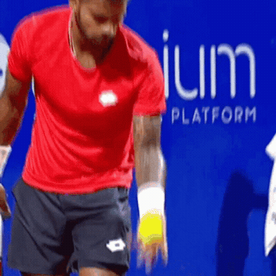 Man In Red Shirt Holding Tennis Ball Blue Sign Platform GIF