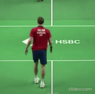Man In Red Shirt Holding Tennis Racket On Court GIF