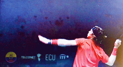 Man In Red Shirt Holding Tennis Racquet In Front Of ECU ITF Sign GIF