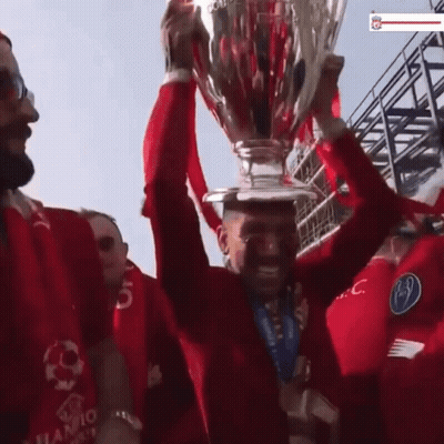 Man In Red Shirt Holding Trophy GIF