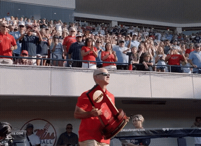 Man In Red Shirt Holding Trophy At Baseball Game GIF