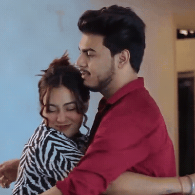 Man In Red Shirt Holding Woman In Zebra Print Dress GIF