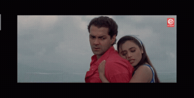 Man In Red Shirt Hugging Woman In Blue Tank Top GIF