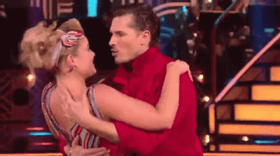 Man In Red Shirt Hugging Woman In Striped Dress GIF